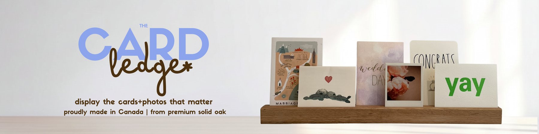 TheCardLedge oak display holding a row of greeting cards and photos